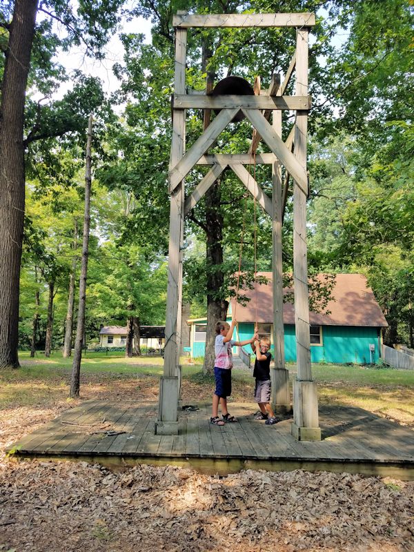 Camp bell rung by two small boys