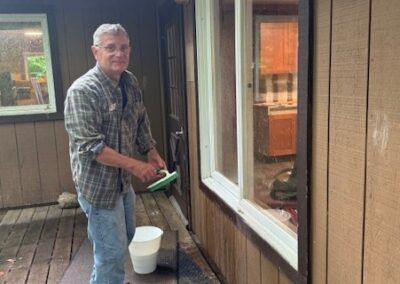 man cleaning a window from the outside