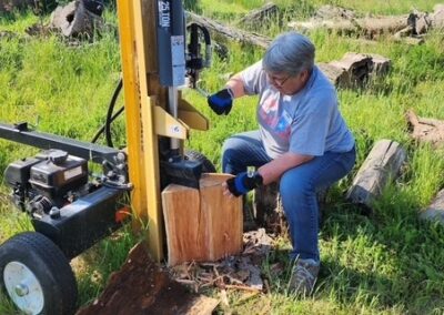 worker using a large log splitter