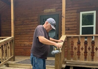 volunteer repairing a handrail